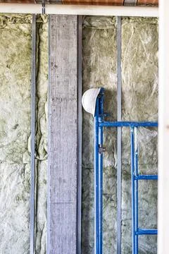 Construction site wall with insulation and scaffolding 스톡 사진