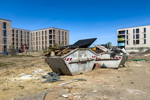 Construction site with waste containers and building structures 写真素材