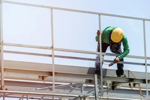 In the construction site, the welding workers at work., worker weld metal in Stock Photos