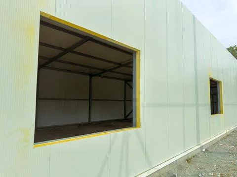 Construction site with windows cut out in a building structure during the day Stock Photos