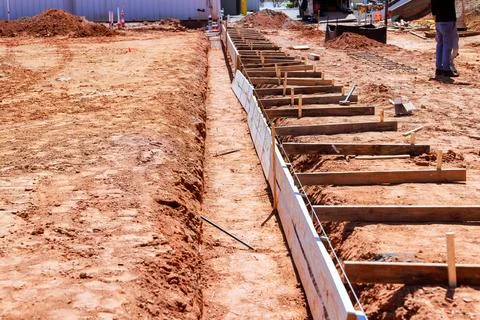 Construction site with wooden forms dirt for pouring concrete foundations Fotos de archivo