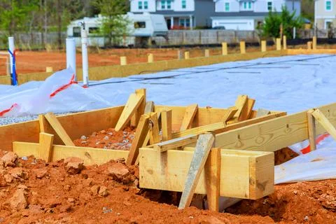 Construction site wooden forms for foundation new building in residential are Fotos de archivo