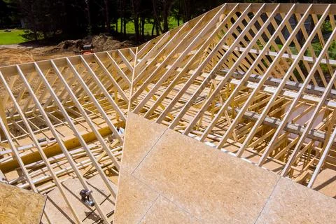Construction site wooden roofing framework of building in progress Stock Photos