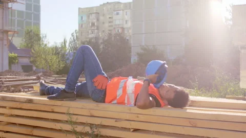 In a construction site worker Afro American in a break time take a nap outside Stock Footage 141181346
