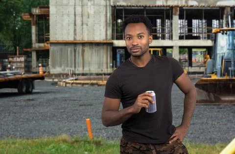 Construction site worker on break drinking soda stressed job tired employee Stock Photos