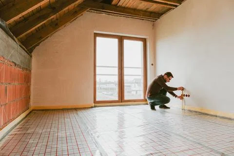 Construction site worker checking the measurements Stock Photos
