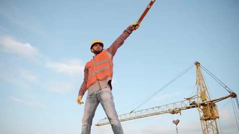 Construction site worker directing traffic at a busy development area Video stock 286051200
