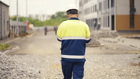 A Construction Site Worker Dressed in Safety Gear Actively Engaged in Their Job Stock Footage 312632697