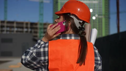 Construction site worker examines blueprints carefully, ensuring detailed design Stock Footage 311860585