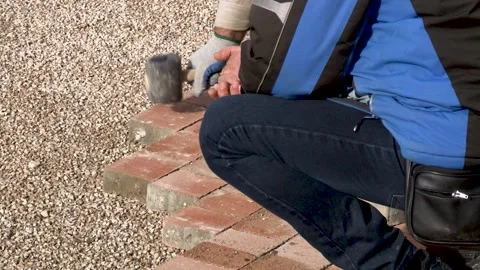 Construction site, worker installing concrete brick pavement. Stock Footage 234132307
