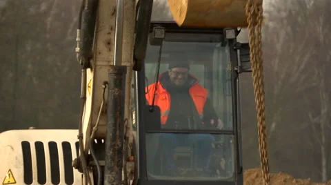 Construction site, worker operating a digger Stock Footage 60448165