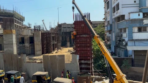 Construction Site Worker Operating Drill on Pillar Daylight Footage Stockbeeldmateriaal 333083381