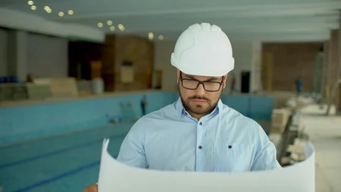 On a construction site, a worker or an engineer or architect controls the design Stock Footage 86949911