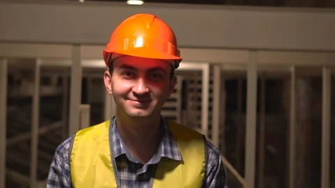 On a construction site, a worker or engineer or architect is looking at camera Stock Footage 89085109