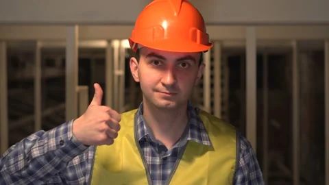 On a construction site, a worker or engineer or architect is showing thumbs up Stock Footage 89087299