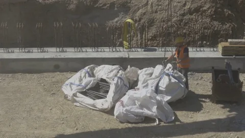 Construction Site, Worker Securing Heavy Equipment Stock Footage 75040596
