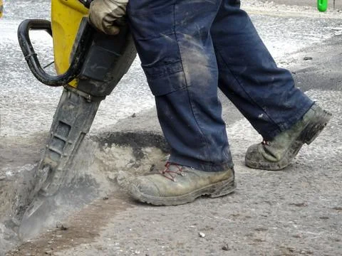 Construction Site Worker Using A Jackhammer Stock Photos