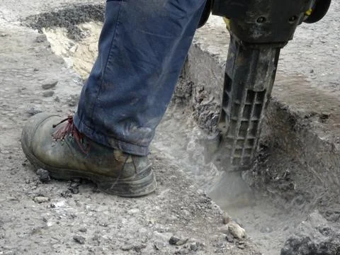 Construction Site Worker Using A Jackhammer Foto stock
