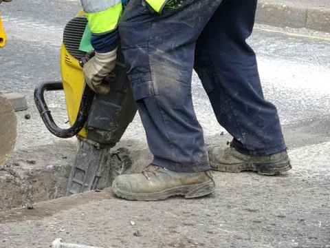 Construction Site Worker Using A Jackhammer Stock Photos
