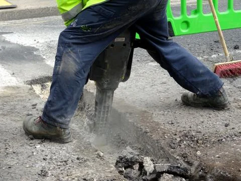 Construction Site Worker Using A Jackhammer Stock Photos