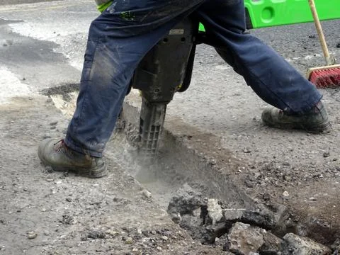 Construction Site Worker Using A Jackhammer Stock Photos