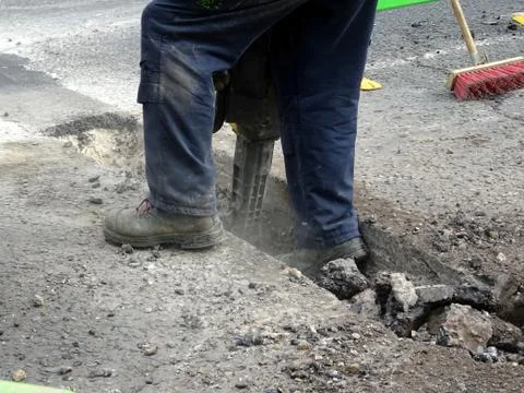Construction Site Worker Using A Jackhammer Stock Photos