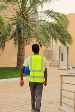 Construction site worker walking for work in Arab country. surveyor, foreman, Stock Photos