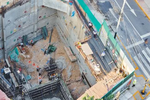 Construction site workers building a city structure foundation Stock Photos