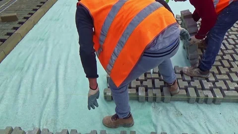 Construction site with workers laying interlocking concrete pavers. Close-up  Video stock 301640952