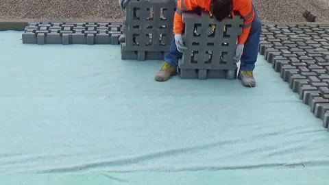 Construction site with workers laying interlocking concrete pavers. Close-up  Video stock 301641373