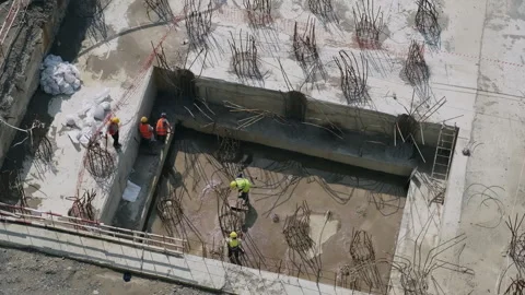 Construction site. Workers preparing foundation using reinforcement bars Stock Footage 280688008