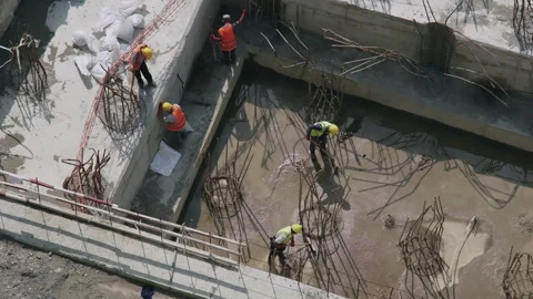 Construction site. Workers preparing foundation using reinforcement bars Stock Footage 280688070