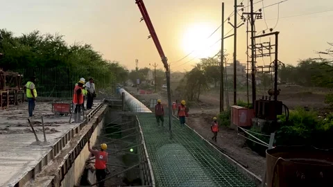 Construction site workers using a concrete pump to pour wet cement Stock Footage 336942730