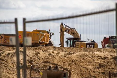 Construction site with working excavators and trucks digging sand Stock Photos