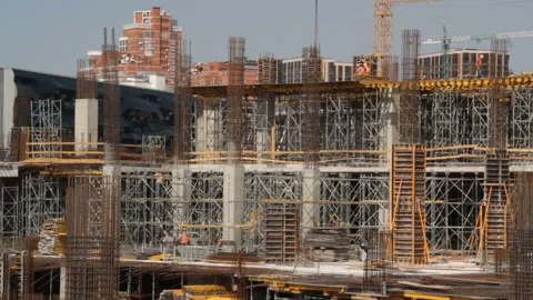 Construction site, working people, cranes, visible residential buildings Stock Footage 103281987