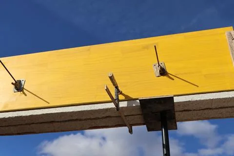 Construction site with yellow wooden formwork and blue sky background Foto stock