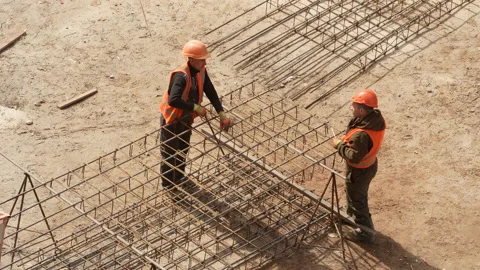 Construction site,caucasian  workers in helmets uniforms.structures from iron Stock Footage 172135282
