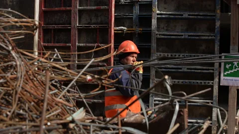 Construction site,caucasian  workers in helmets uniforms.structures from iron Stock Footage 172212989