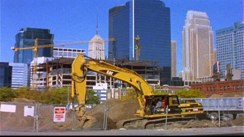 Construction sites downtown yellow machine swings foreground Stock Footage 145784287