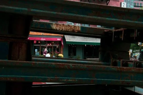 A construction skip frames a sidewalk with people in the East Village Stock Photos