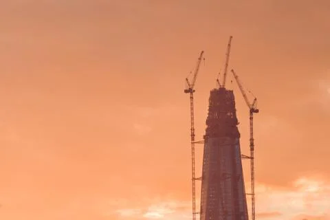 Construction of the skyscraper against the sky at sunset. Copy space. Stock Photos