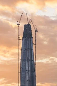 Construction of the skyscraper against the sky at sunset. Stock Photos