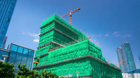 Construction of a skyscraper and green covered fabric construction to protect. Stock Footage 56453598