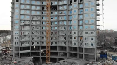 The construction of a skyscraper, next to a high crane. Flying in the heights. Stock Footage 127714342