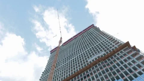 Construction of skyscraper tower crane lifting of concrete plinths Stock Footage 165457067