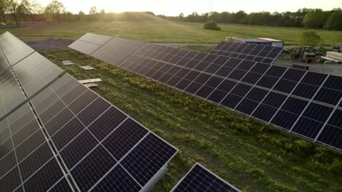 Construction of a solar panel farm, seen from the air at sunset. Stock Footage 241793085