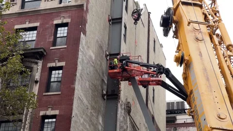 Construction sparks crane man hardhat working building site New York City NYC Stock Footage 254380082