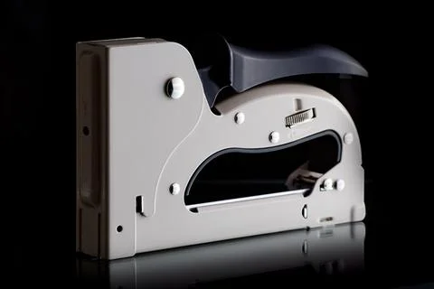 Construction stapler on a black background, construction tool Stock Photos