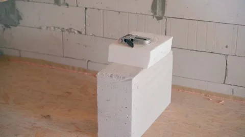 The construction stapler lies on a thick polystyrene foam insulation and on a 動画素材 246838840