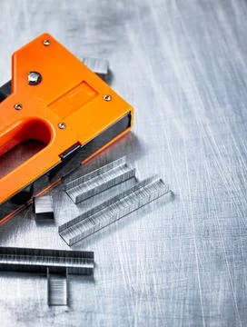 Construction stapler on the table. Stock Photos